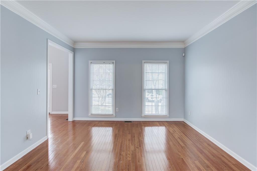 1446 Chadwick Ridge Court Lawrenceville, GA 30043 - Photo 9 of 54 an empty room with wooden floor and windows