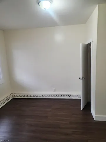 a view of an empty room and wooden floor