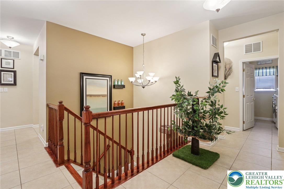 2113 Kingsview Road Lower Macungie Township, PA 18062 - Photo 13 of 62 a view of a hallway to a house with potted plants