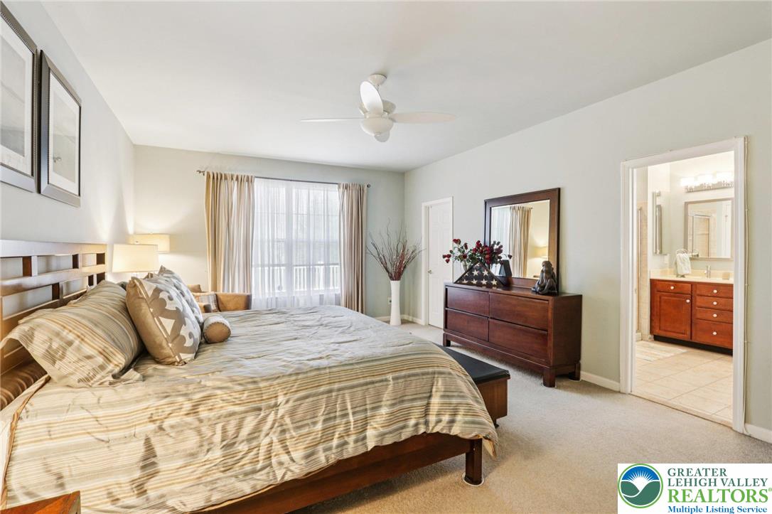 2113 Kingsview Road Lower Macungie Township, PA 18062 - Photo 28 of 62 a bedroom with a large bed and a chandelier