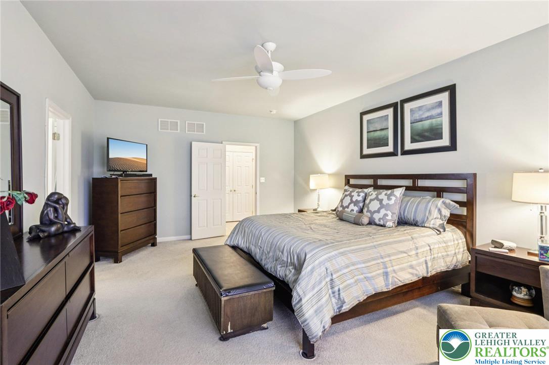 2113 Kingsview Road Lower Macungie Township, PA 18062 - Photo 29 of 62 a bedroom with a bed and a chandelier