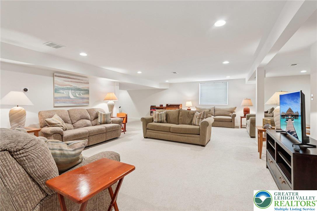 2113 Kingsview Road Lower Macungie Township, PA 18062 - Photo 38 of 62 a living room with furniture flat screen tv and a refrigerator