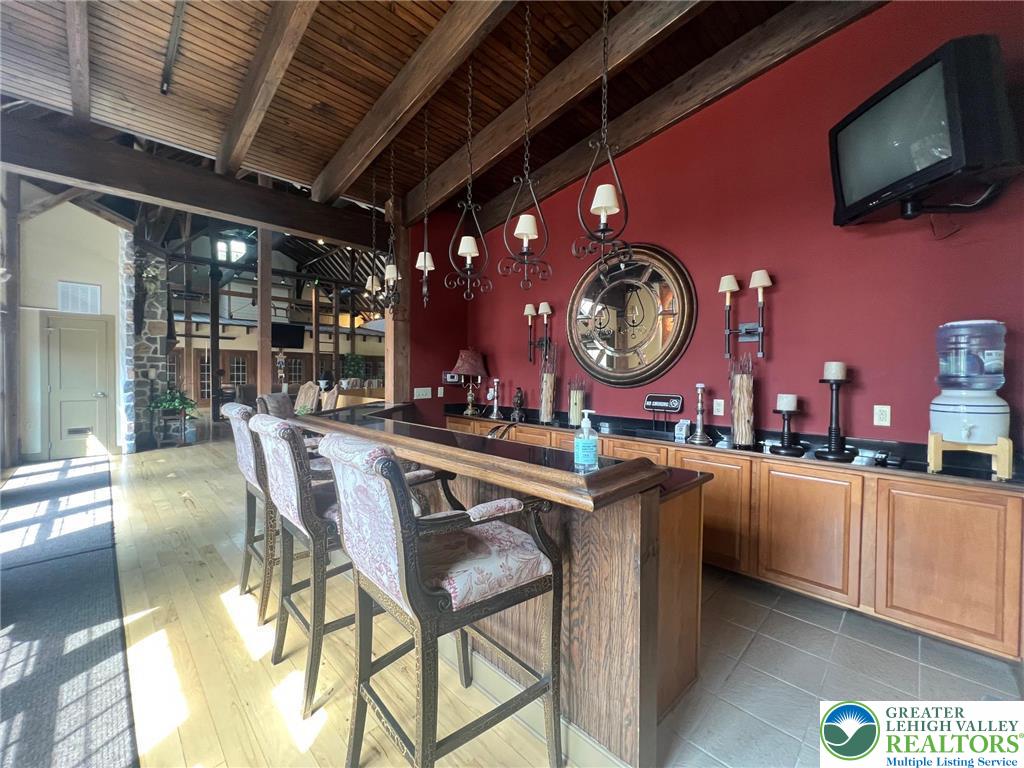 2113 Kingsview Road Lower Macungie Township, PA 18062 - Photo 58 of 62 a kitchen with stainless steel appliances granite countertop a stove a refrigerator a dining table and chairs with the view of the kitchen