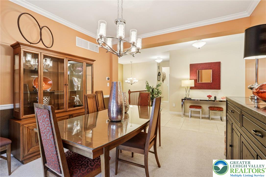 2113 Kingsview Road Lower Macungie Township, PA 18062 - Photo 7 of 62 a view of a dining room with furniture and a chandelier