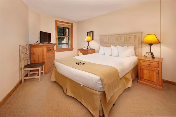 a bedroom with a bed and a flat screen tv