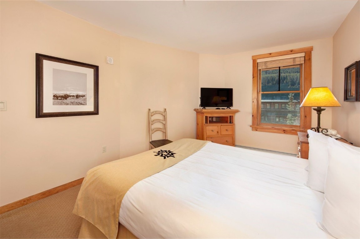 100 Dercum Square, Unit 8371 Keystone, CO 80435 - Photo 14 of 33 a bedroom with a bed and a flat screen tv