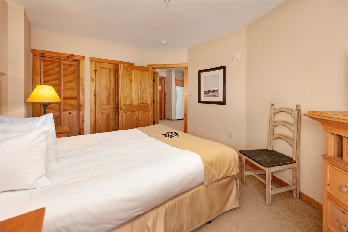 100 Dercum Square, Unit 8371 Keystone, CO 80435 - Photo 15 of 33 a bedroom with a bed and a chandelier