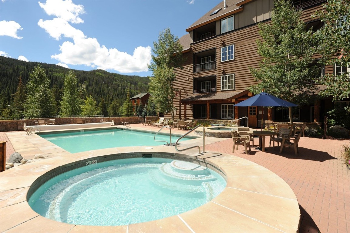 100 Dercum Square, Unit 8371 Keystone, CO 80435 - Photo 23 of 33 a swimming pool with outdoor seating and yard