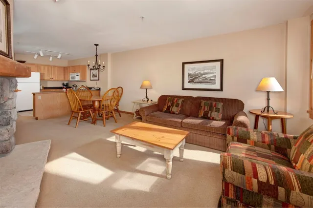 a living room with furniture and a lamp