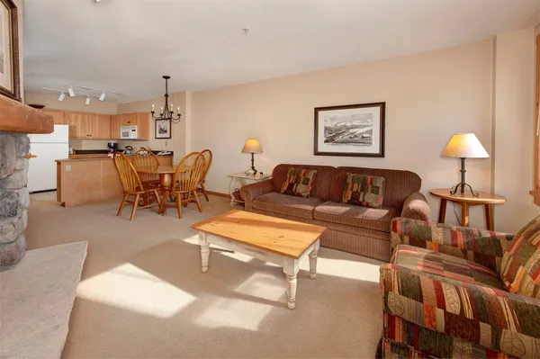 a living room with furniture and a lamp