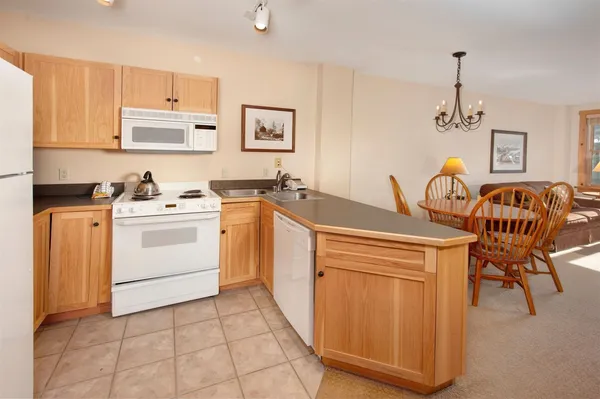 a dining room with furniture and chandelier