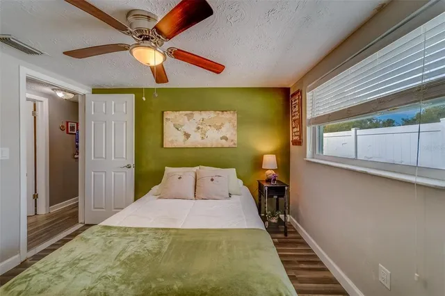 a bathroom with a granite countertop toilet a sink and shower