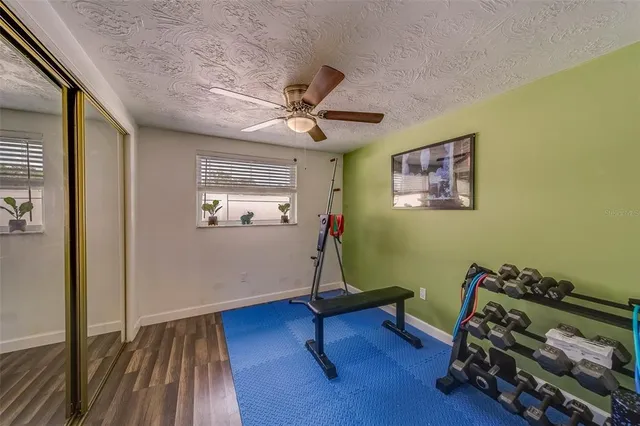 a backyard of a house with dining table and chairs with plants