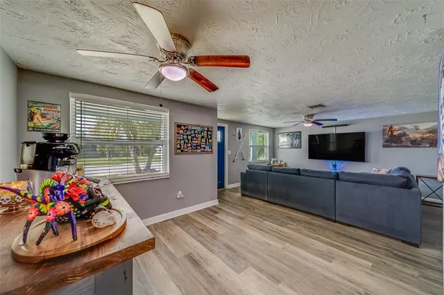 a view of a workspace with furniture window and wooden floor