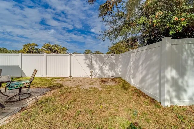 an aerial view of a house with garden space and street view