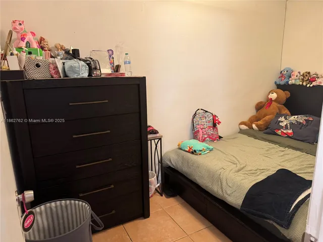 a kitchen with refrigerator and cabinets