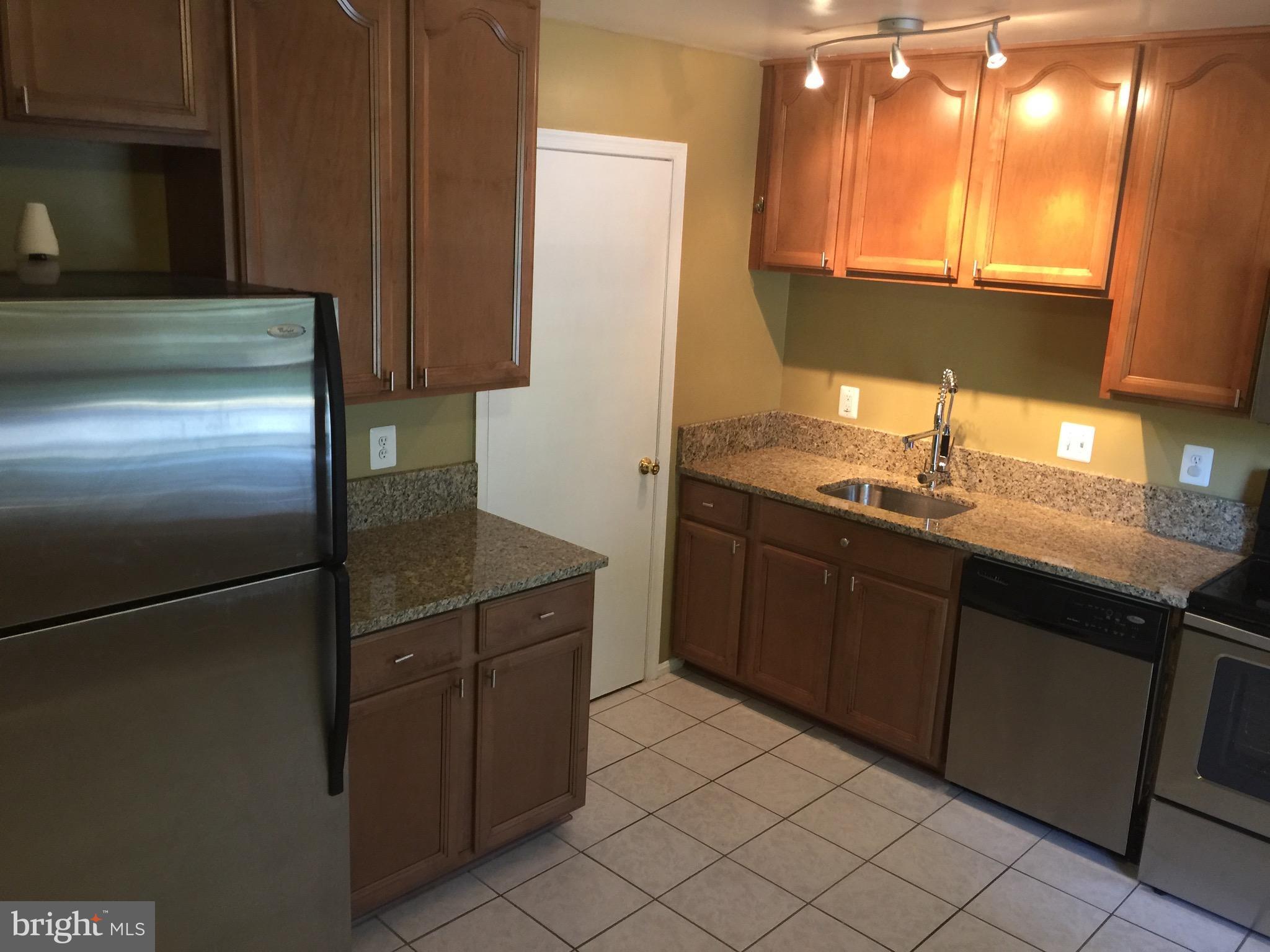 8029 Carbondale Way Springfield, VA 22153 - Photo 2 of 30 a kitchen with a sink refrigerator and cabinets