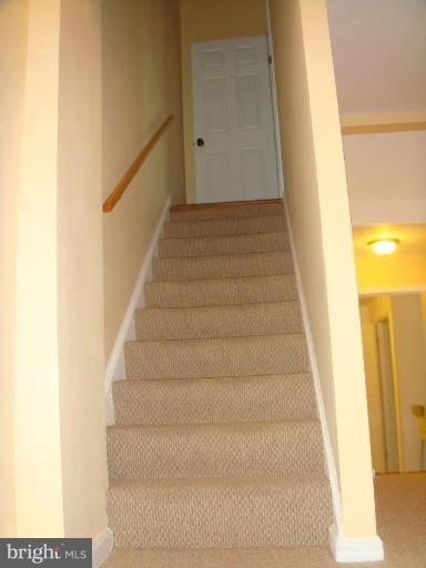 8029 Carbondale Way Springfield, VA 22153 - Photo 11 of 30 a view of staircase with white walls and a white door