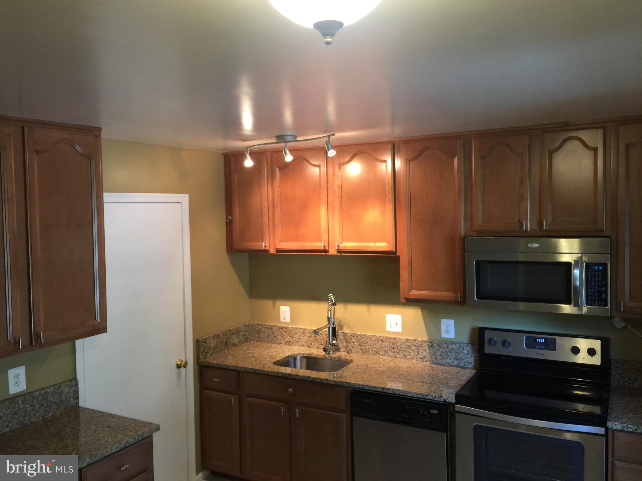 8029 Carbondale Way Springfield, VA 22153 - Photo 4 of 30 a kitchen with a sink and a stove