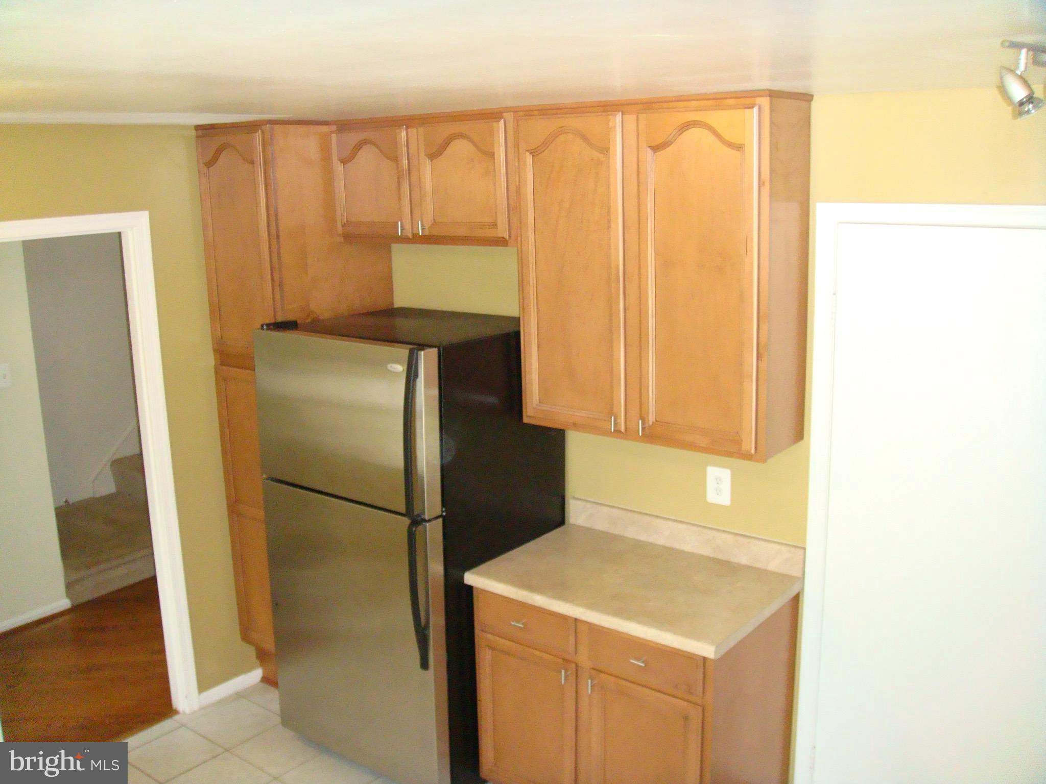 8029 Carbondale Way Springfield, VA 22153 - Photo 5 of 30 a kitchen with a refrigerator and a window