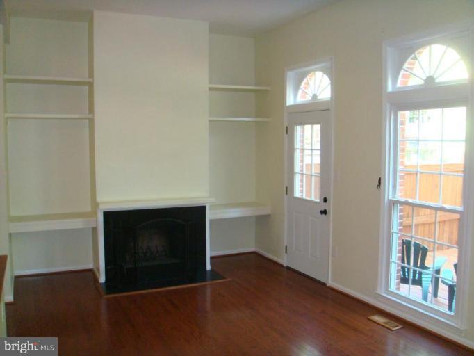 8029 Carbondale Way Springfield, VA 22153 - Photo 9 of 30 a view of an empty room with wooden floor and a window