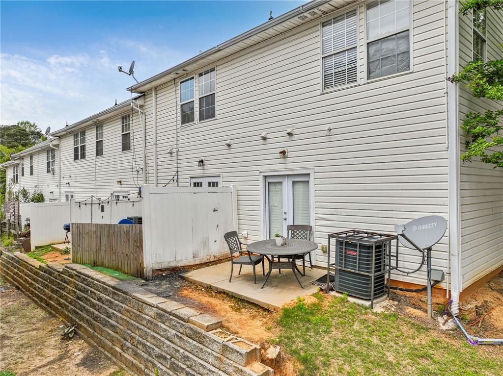 3616 Ginnis Road, Unit 1 Atlanta, GA 30331 - Photo 20 of 20 a view of a patio with table and chairs with wooden floor and fence