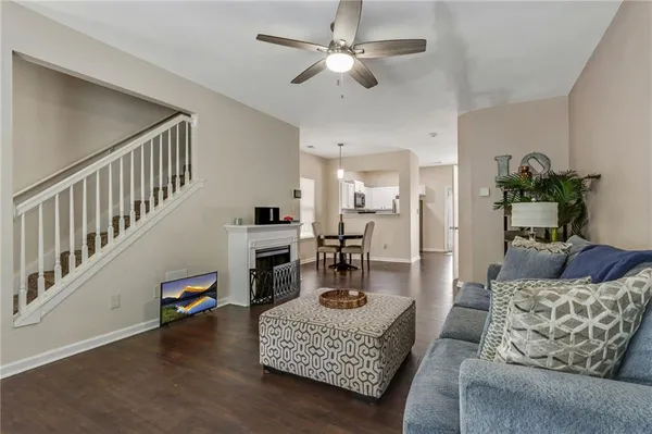a living room with furniture and a chandelier