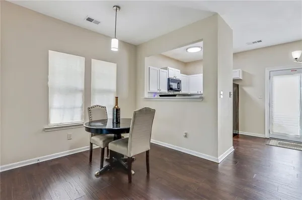 a view of a dining room with furniture and wooden floor