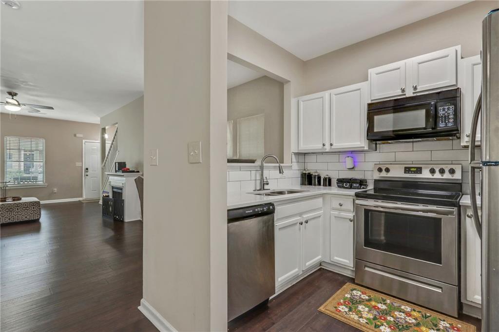 3616 Ginnis Road, Unit 1 Atlanta, GA 30331 - Photo 10 of 20 a kitchen with stainless steel appliances a stove microwave and sink