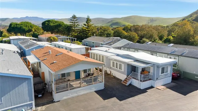 an aerial view of a house with a mountain