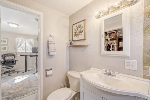 a bathroom with a toilet sink and mirror