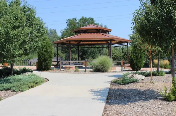 a view of a patio with table and chairs under an umbrella