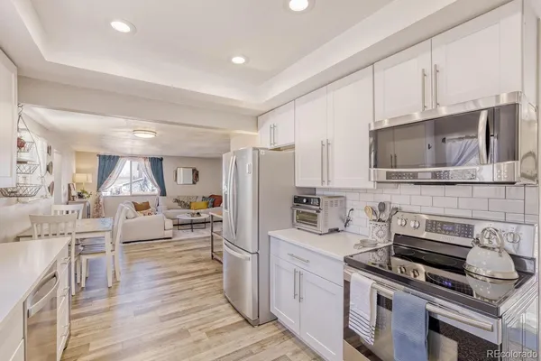 a kitchen with stainless steel appliances a stove sink microwave and cabinets