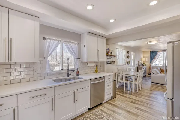 a kitchen with appliances a sink and cabinets
