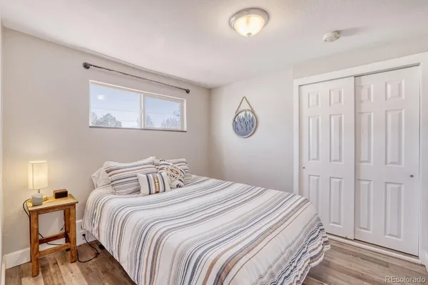 a bedroom with a bed and a painting on the wall