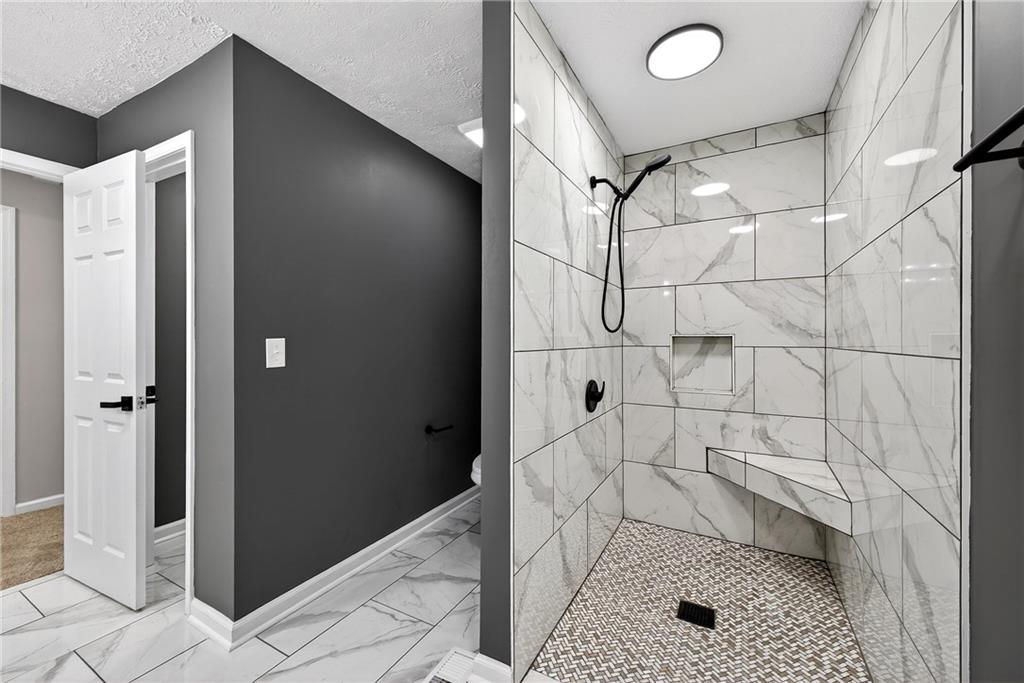 187 Old Timber Road Lawrenceville, GA 30046 - Photo 14 of 32 a bathroom with a shower