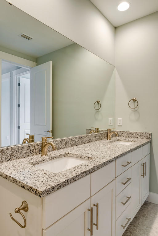Lot 86 Constant Avenue Santa Rosa Beach, FL 32459 - Photo 16 of 31 a bathroom with a granite countertop sink and white cabinets