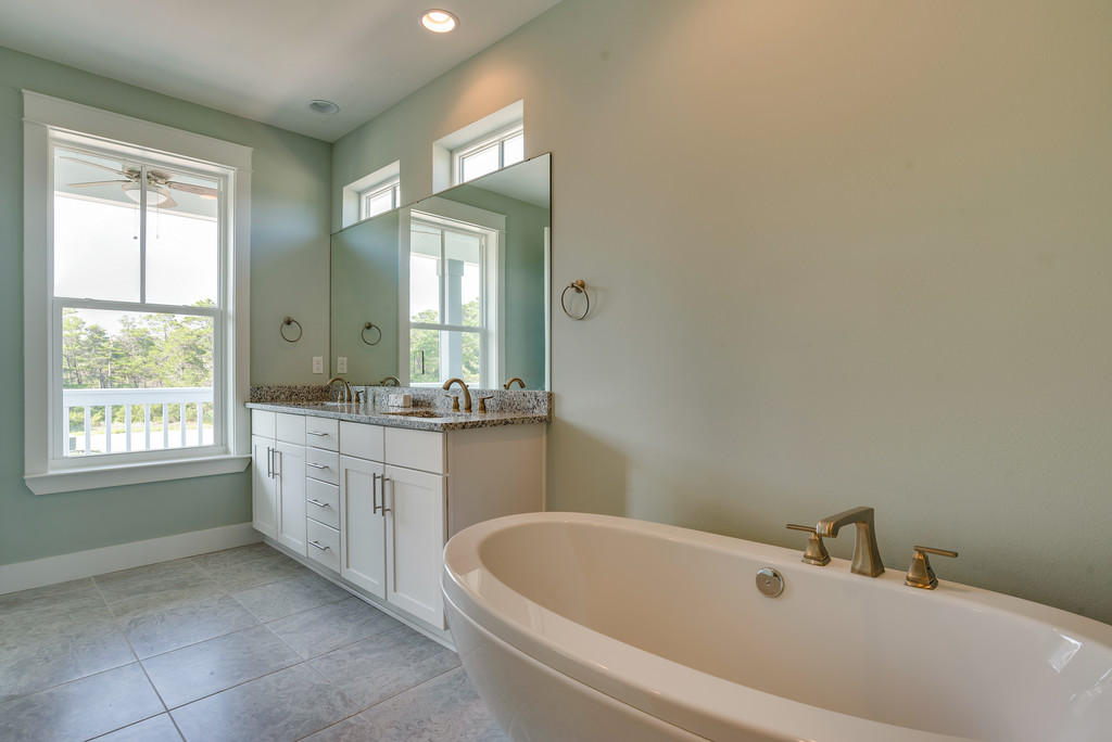 Lot 86 Constant Avenue Santa Rosa Beach, FL 32459 - Photo 25 of 31 a bathroom with a bathtub sink and mirror