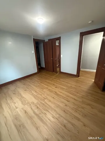 an empty room with closet and mirror
