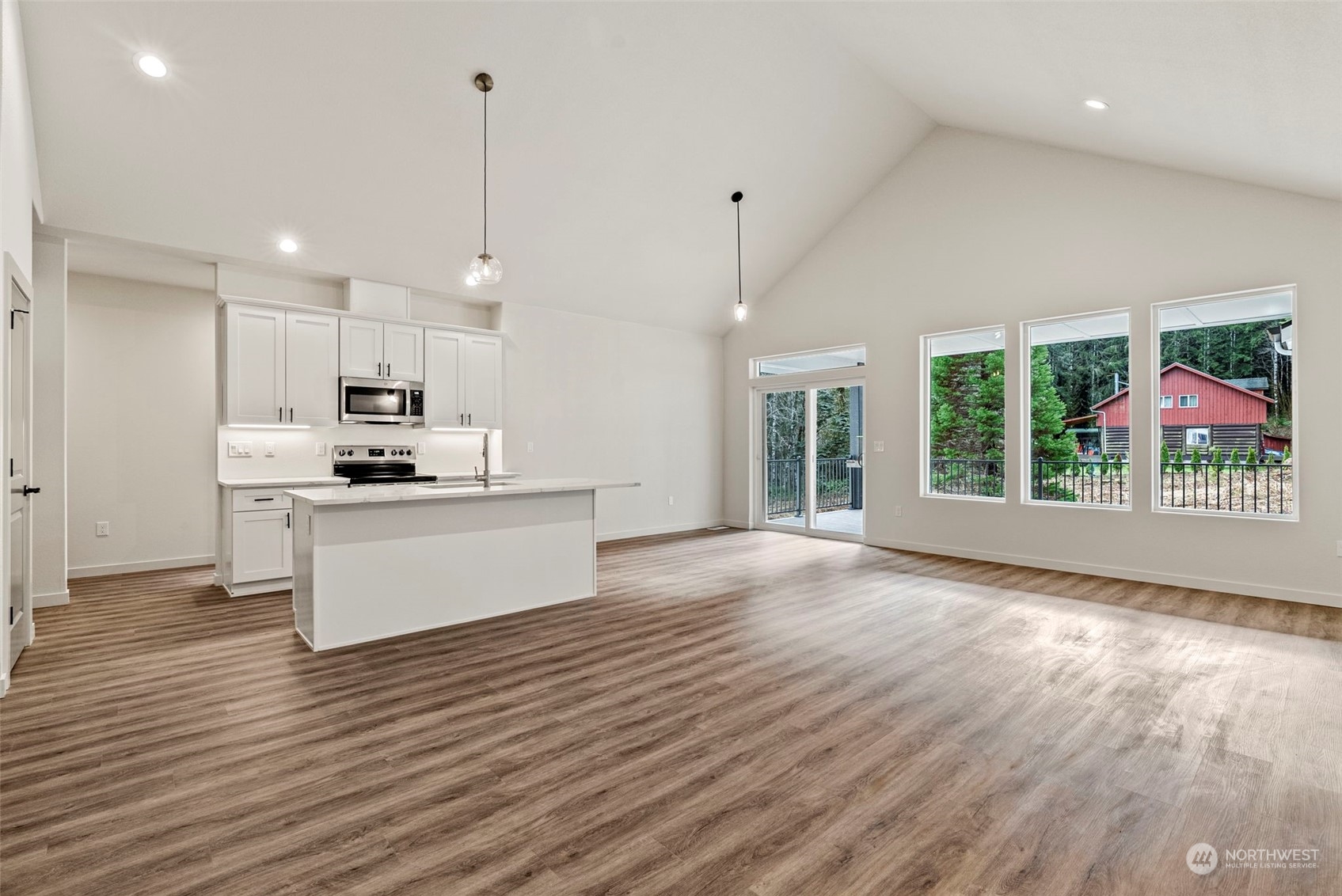147 Hunter Road Longview, WA 98632 - Photo 11 of 31 a view of kitchen with kitchen island wooden floors appliances and cabinets