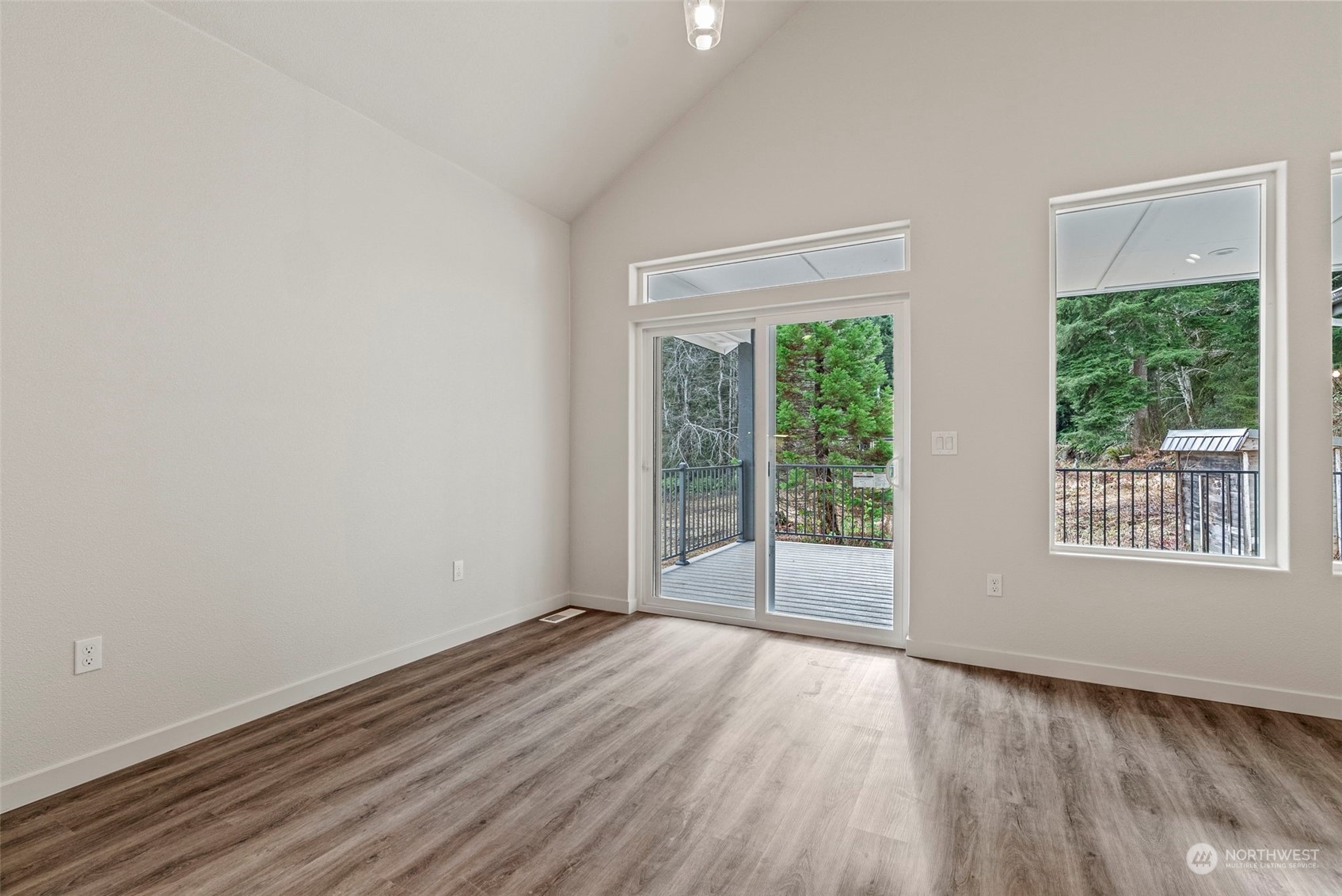 147 Hunter Road Longview, WA 98632 - Photo 13 of 31 an empty room with wooden floor and windows