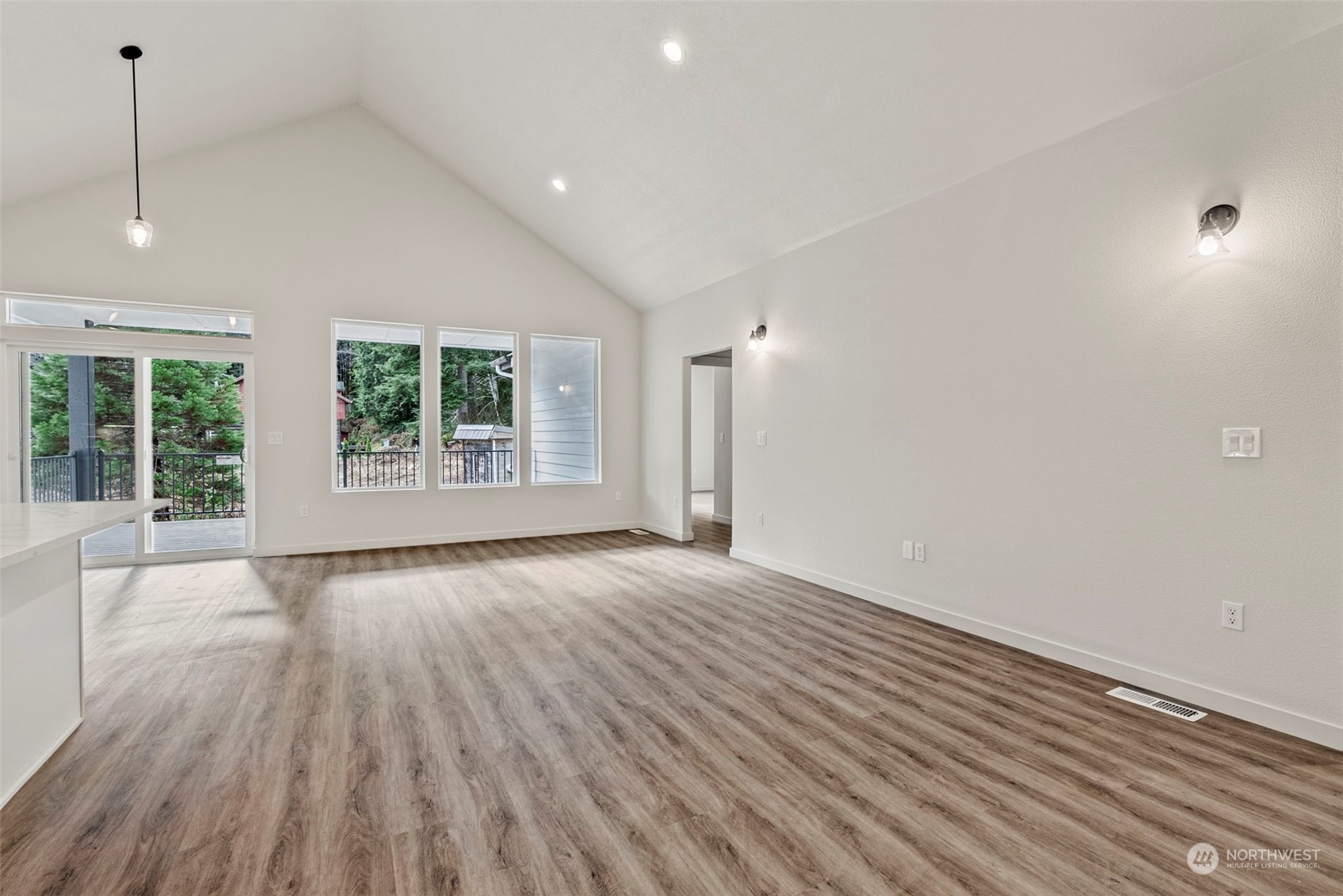 147 Hunter Road Longview, WA 98632 - Photo 15 of 31 an empty room with wooden floor and windows