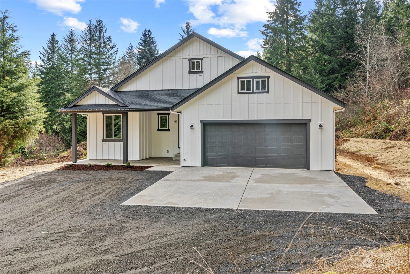 147 Hunter Road Longview, WA 98632 - Photo 2 of 31 a front view of a house with a yard and garage
