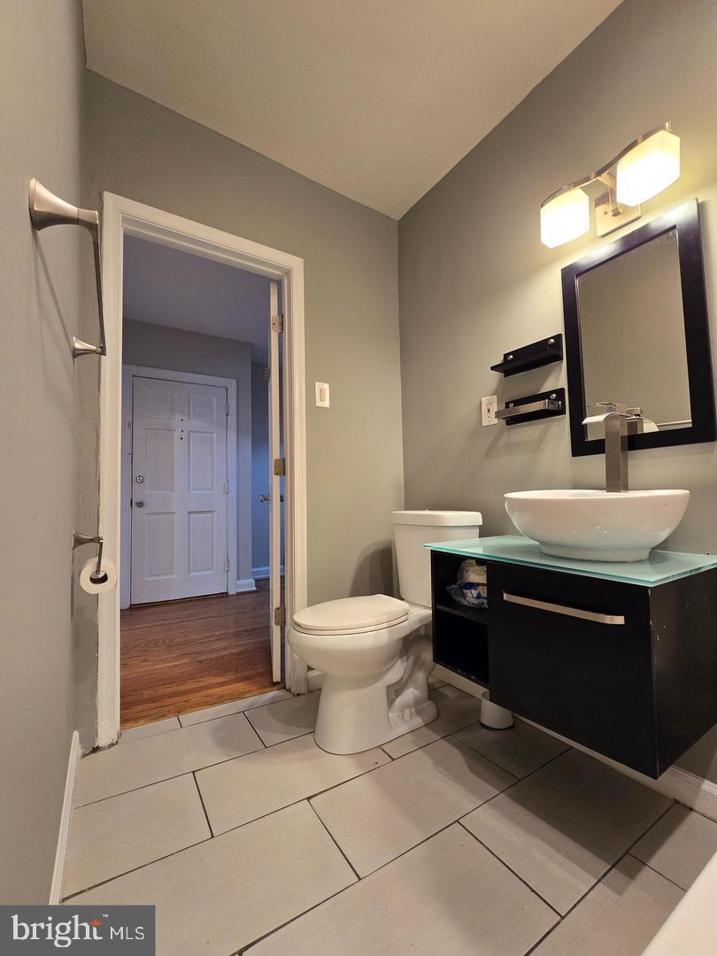 4044 7th Street Northeast, Unit 4 Washington, DC 20017 - Photo 3 of 9 a bathroom with a sink a toilet and mirror