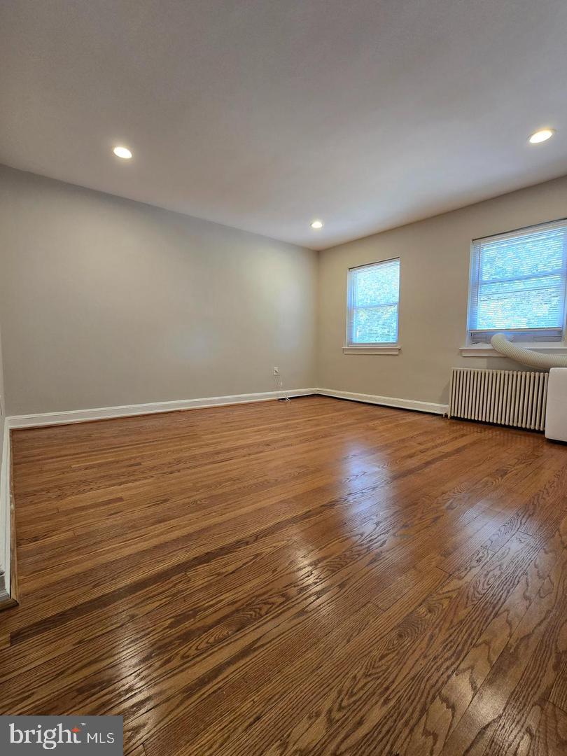 4044 7th Street Northeast, Unit 4 Washington, DC 20017 - Photo 4 of 9 an empty room with wooden floor and windows