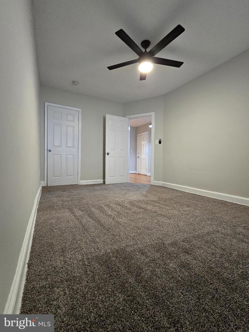 4044 7th Street Northeast, Unit 4 Washington, DC 20017 - Photo 6 of 9 an empty room with ceiling fan and window