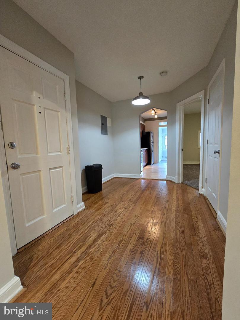 4044 7th Street Northeast, Unit 4 Washington, DC 20017 - Photo 8 of 9 a view of a livingroom with wooden floor and staircase