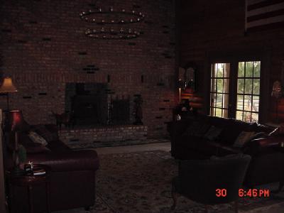 13645 Millerton Road Prather, CA 93651 - Photo 4 of 9 Full brick wall in living room with insert. Wonderful chandelier. Two sets of french doors from living room allow a great view of the Sierra's.