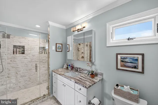 a bedroom with a bed and a flat tv screen on the dresser