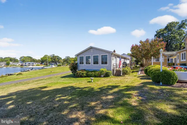 a view of a house with a yard and sitting area